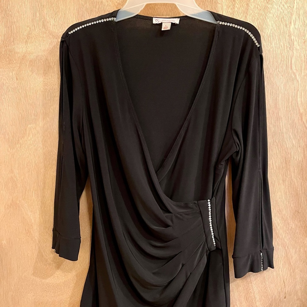 Dress barn black top with rhinestone trim, size large.  Three-quarter sleeve.